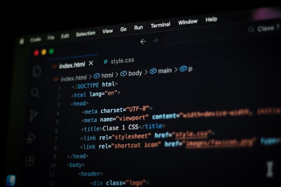A black laptop with a glowing screen displaying lines of colorful code or text, positioned on a dark surface. To the right of the laptop, there is a white baseball cap with the Puma logo embroidered i